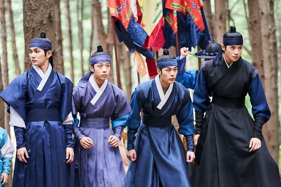 Five princes in hanbok walking through a forest in Under the Queen's Umbrella